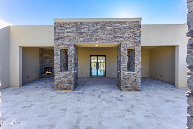 view of patio / terrace with an outdoor stone fireplace