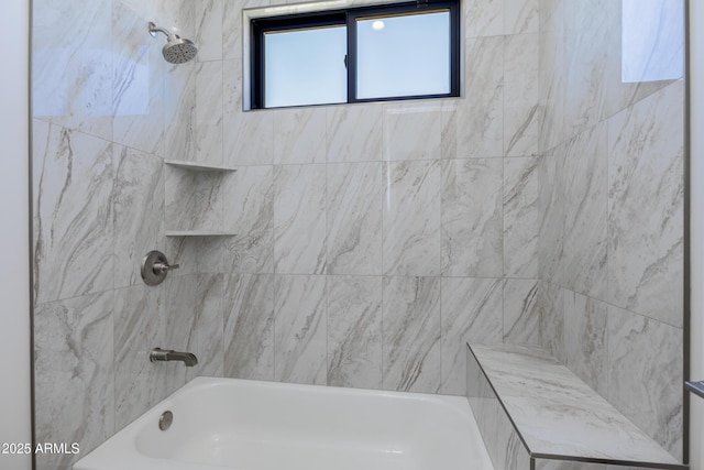 bathroom featuring tiled shower / bath