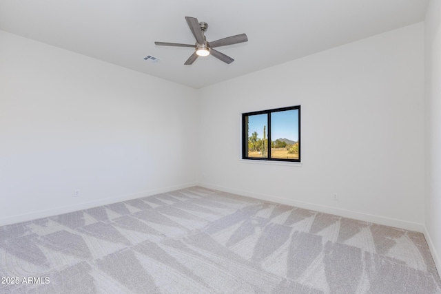 carpeted spare room with ceiling fan