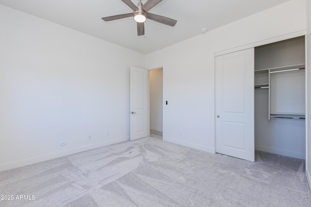 unfurnished bedroom featuring ceiling fan, light colored carpet, and a closet