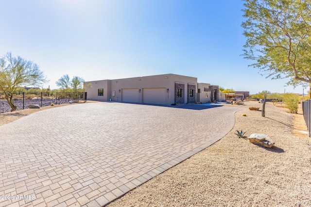 pueblo revival-style home with a garage