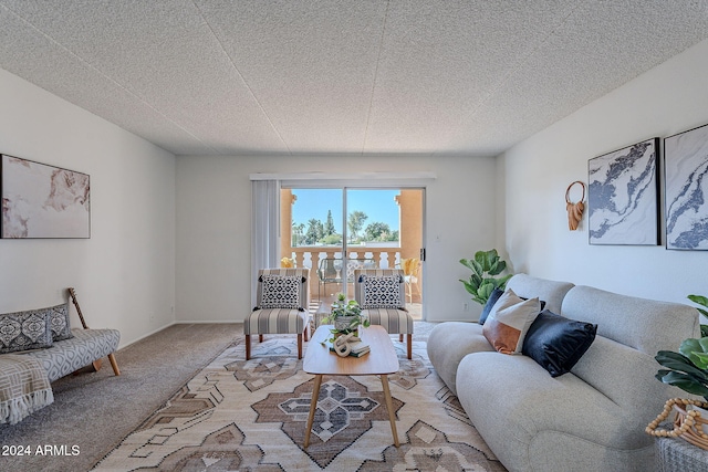 living room with carpet floors and a textured ceiling