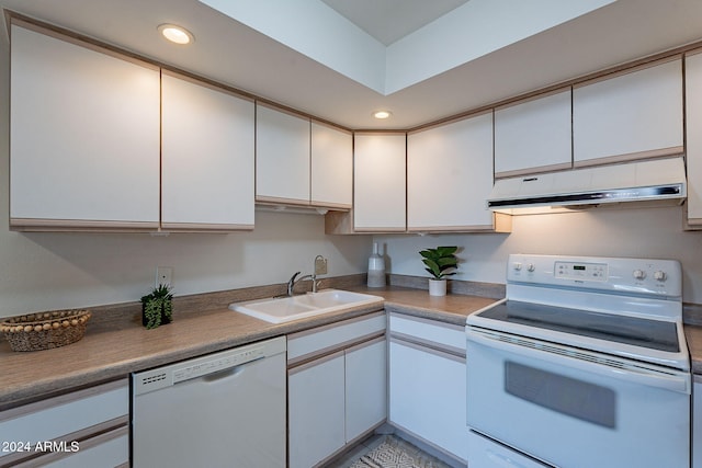 kitchen featuring white cabinetry, sink, and white appliances