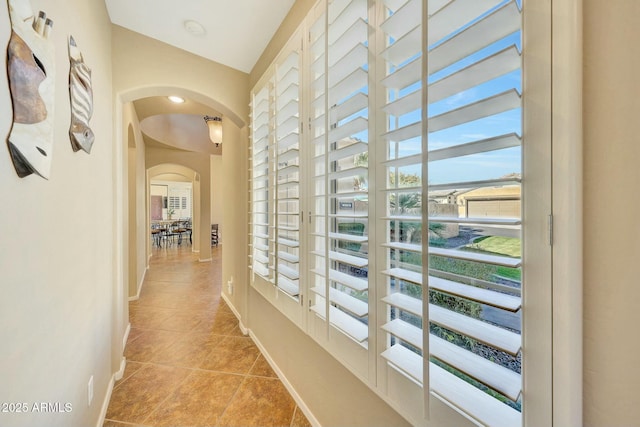 corridor featuring light tile patterned floors