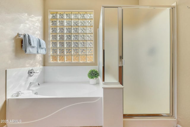 bathroom featuring shower with separate bathtub