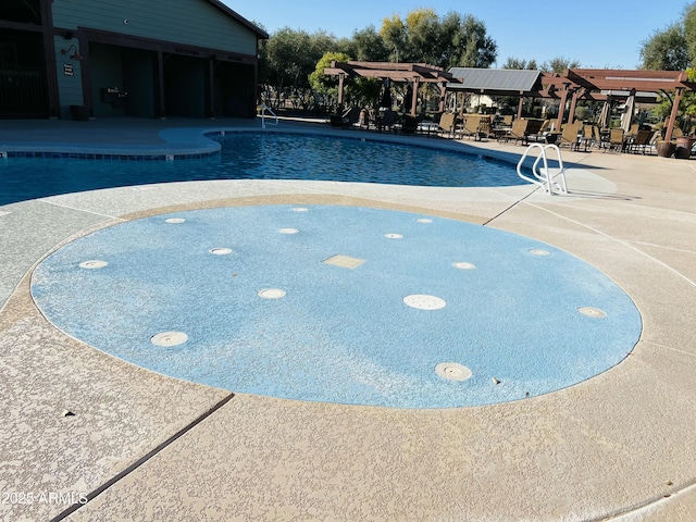 view of swimming pool with a pergola and a patio