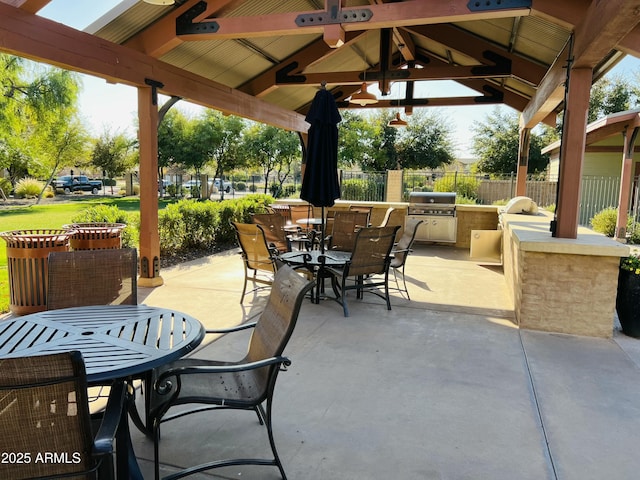 view of patio / terrace with exterior kitchen, a gazebo, a grill, and ceiling fan