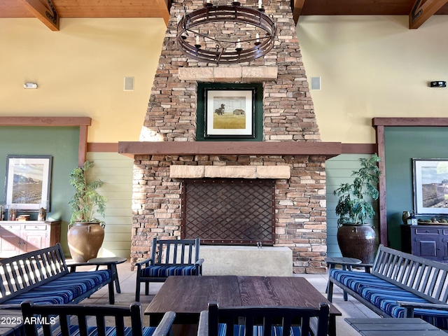 living room featuring a towering ceiling, beam ceiling, and wood walls