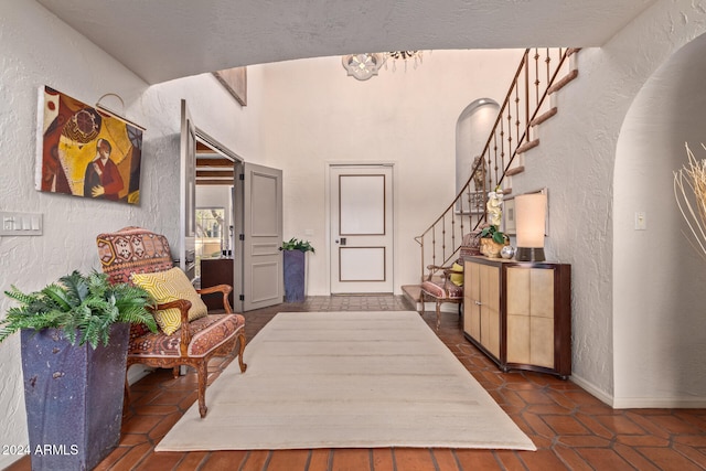 foyer featuring dark tile patterned floors