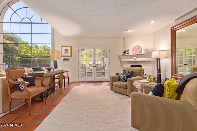 tiled living room with french doors, a textured ceiling, and a healthy amount of sunlight