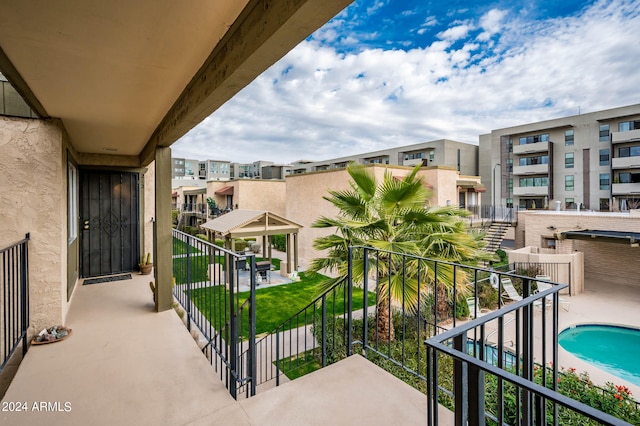 balcony featuring a community pool