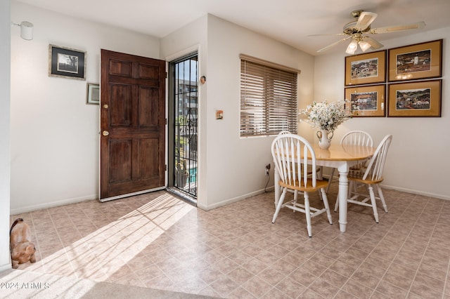 dining area featuring light tile floors, ceiling fan, and a wealth of natural light