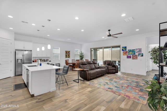 3913 W Mcneil St, Laveen, AZ 85339 - kitchen featuring visible vents, a sink, light countertops, appliances with stainless steel finishes, and a kitchen bar