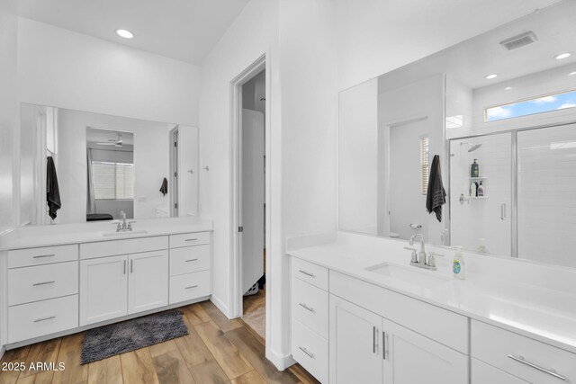 3913 W Mcneil St, Laveen, AZ 85339 - bathroom featuring a sink, two vanities, wood finished floors, and a shower stall
