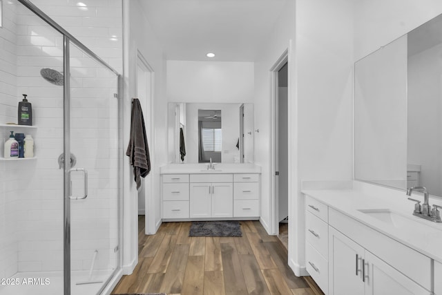 3913 W Mcneil St, Laveen, AZ 85339 - bathroom with a shower stall, two vanities, wood finished floors, and a sink