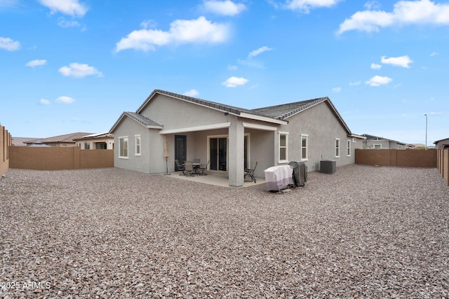 3913 W Mcneil St, Laveen, AZ 85339 - back of property with stucco siding, a patio, central AC unit, and a fenced backyard