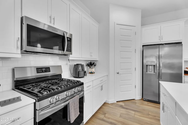 3913 W Mcneil St, Laveen, AZ 85339 - kitchen featuring light wood finished floors, decorative backsplash, stainless steel appliances, and light countertops