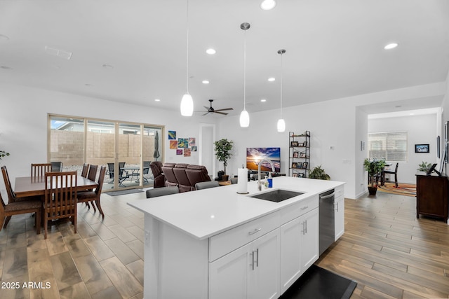 3913 W Mcneil St, Laveen, AZ 85339 - kitchen with a sink, white cabinets, light wood finished floors, dishwasher, and light countertops