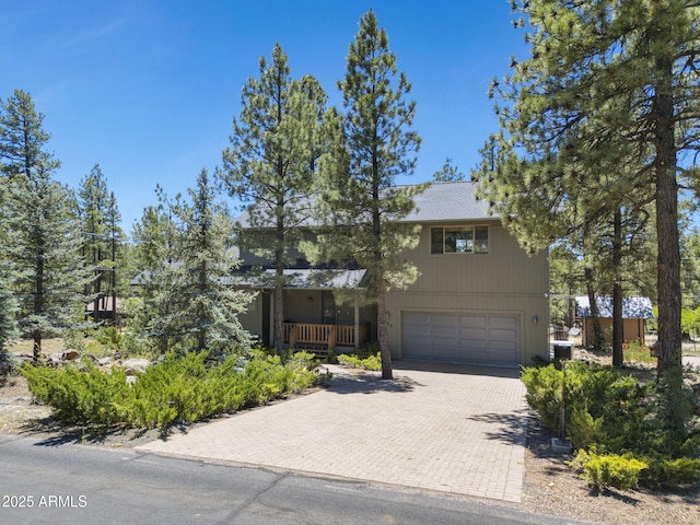 525 E Turkey Trl, Munds Park, AZ 86017 - view of front facade with an attached garage, decorative driveway, and a porch