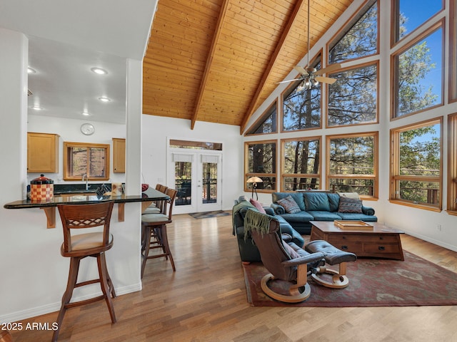 525 E Turkey Trl, Munds Park, AZ 86017 - living area with a wood ceiling with exposed beams, plenty of natural light, high vaulted ceiling, light wood finished floors, and ceiling fan