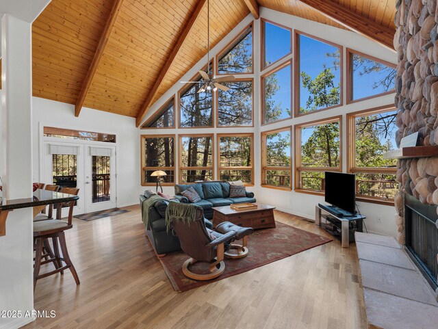 525 E Turkey Trl, Munds Park, AZ 86017 - living room featuring high vaulted ceiling, a ceiling fan, wood finished floors, a wooden ceiling with exposed beams, and a fireplace