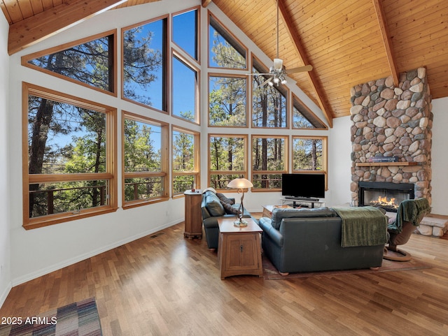 525 E Turkey Trl, Munds Park, AZ 86017 - living area with a wood ceiling with exposed beams, high vaulted ceiling, a fireplace, a ceiling fan, and light wood-style floors