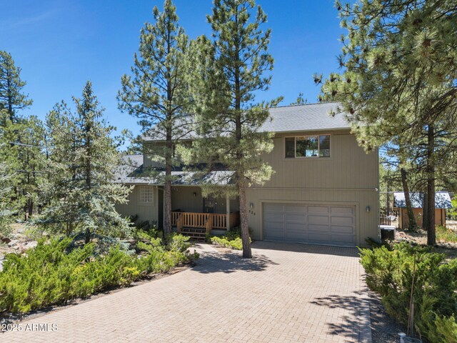 525 E Turkey Trl, Munds Park, AZ 86017 - view of front of house featuring an attached garage and decorative driveway