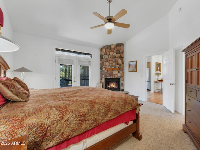525 E Turkey Trl, Munds Park, AZ 86017 - bedroom featuring access to outside, light carpet, a stone fireplace, ceiling fan, and high vaulted ceiling