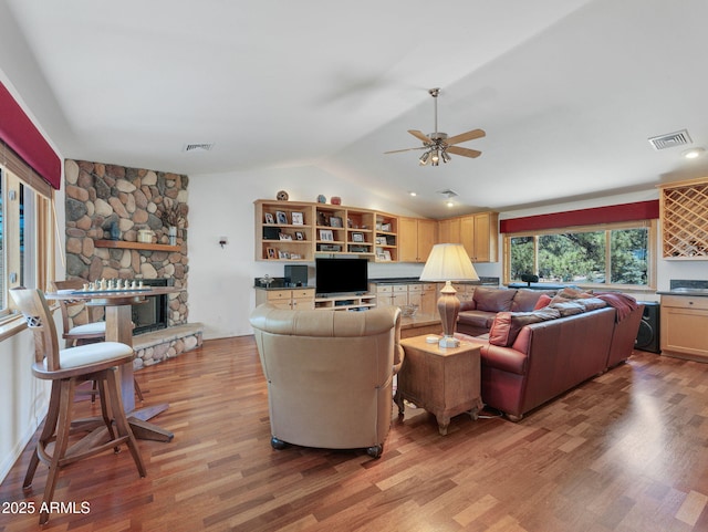 525 E Turkey Trl, Munds Park, AZ 86017 - living area with lofted ceiling, light wood-style floors, a fireplace, and a ceiling fan