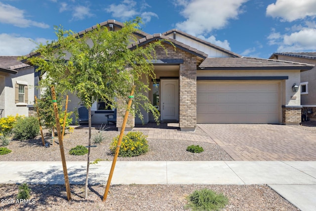 20606 E Avenida Del Valle Ct, Queen Creek, AZ 85142 - view of front of property with a tiled roof, decorative driveway, an attached garage, stone siding, and stucco siding