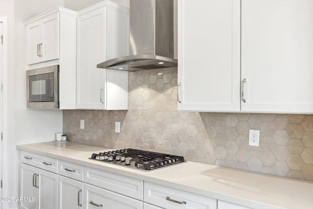 20606 E Avenida Del Valle Ct, Queen Creek, AZ 85142 - kitchen with wall chimney range hood, built in microwave, light countertops, stainless steel gas stovetop, and white cabinetry