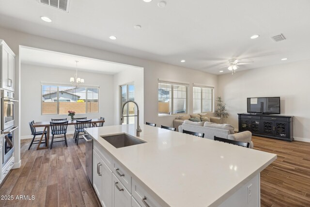 20606 E Avenida Del Valle Ct, Queen Creek, AZ 85142 - kitchen with light countertops, visible vents, a sink, and dark wood-type flooring