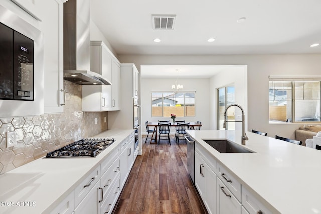 20606 E Avenida Del Valle Ct, Queen Creek, AZ 85142 - kitchen with visible vents, dark wood-style floors, wall chimney exhaust hood, a sink, and stainless steel appliances