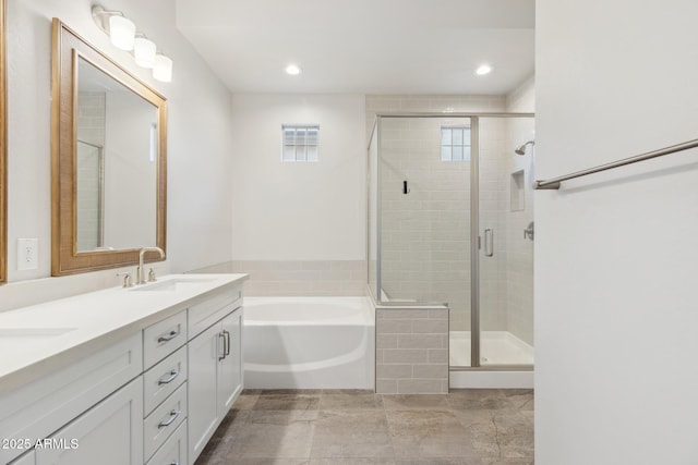 20606 E Avenida Del Valle Ct, Queen Creek, AZ 85142 - bathroom with double vanity, a bath, a stall shower, a sink, and recessed lighting