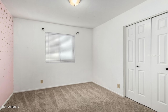 unfurnished bedroom featuring a closet and carpet flooring