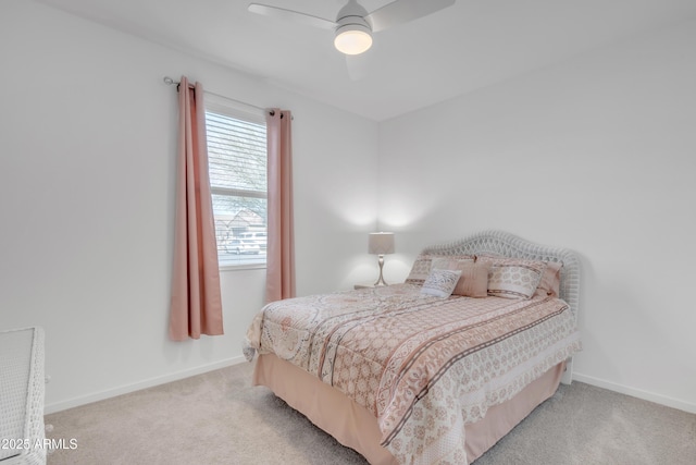 bedroom featuring baseboards, a ceiling fan, and light colored carpet