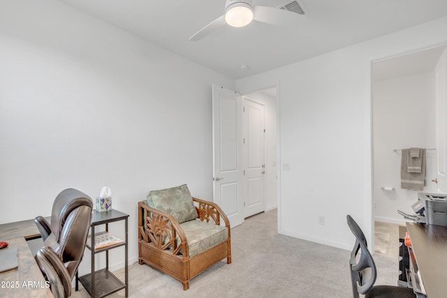 office area with light colored carpet, visible vents, ceiling fan, and baseboards