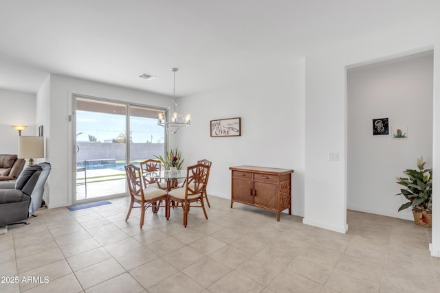 dining space with visible vents, a notable chandelier, baseboards, and light tile patterned flooring