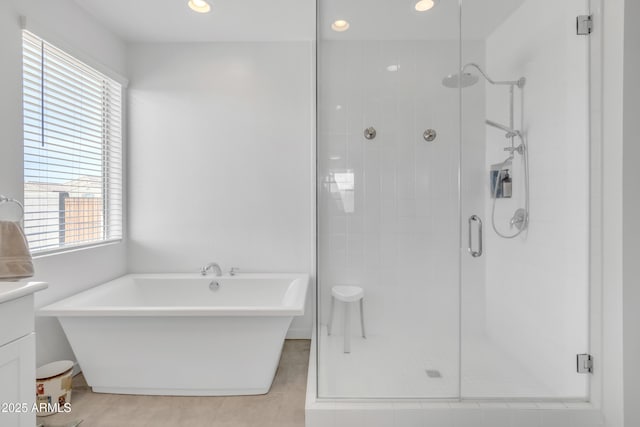 full bath with a freestanding tub, a shower stall, vanity, and recessed lighting