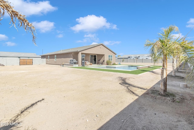 back of house with a patio, stucco siding, fence, and an outdoor pool