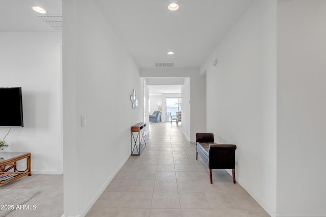 hallway featuring recessed lighting, visible vents, baseboards, and light tile patterned floors