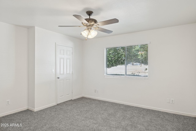 carpeted spare room featuring ceiling fan