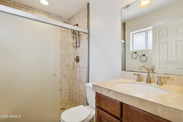 bathroom featuring vanity, walk in shower, and toilet