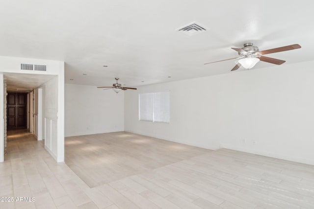 spare room with light hardwood / wood-style flooring and ceiling fan