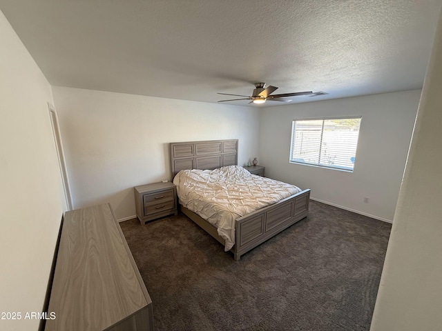 bedroom featuring a ceiling fan, dark colored carpet, a textured ceiling, and baseboards