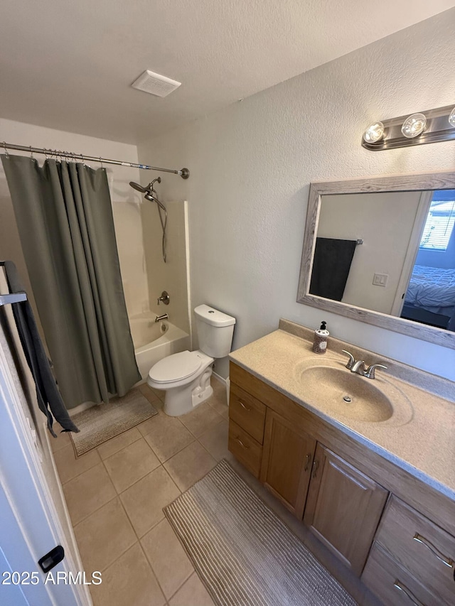 bathroom featuring toilet, vanity, tile patterned flooring, shower / bath combination with curtain, and a textured ceiling