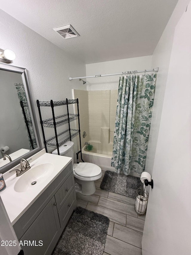 full bath with shower / tub combo with curtain, visible vents, a textured wall, a textured ceiling, and vanity