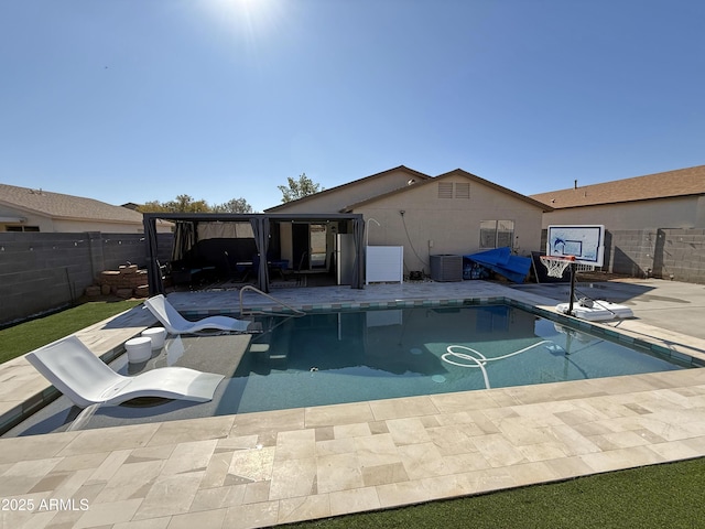 view of swimming pool with a fenced in pool, fence, and a patio