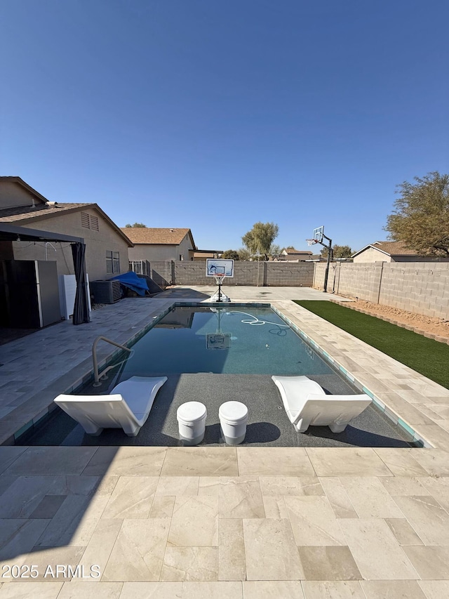 view of swimming pool featuring a patio area, a fenced backyard, and a fenced in pool