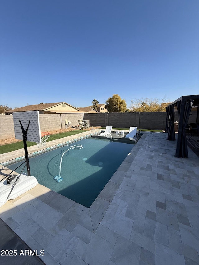 view of swimming pool with a patio area and a fenced backyard